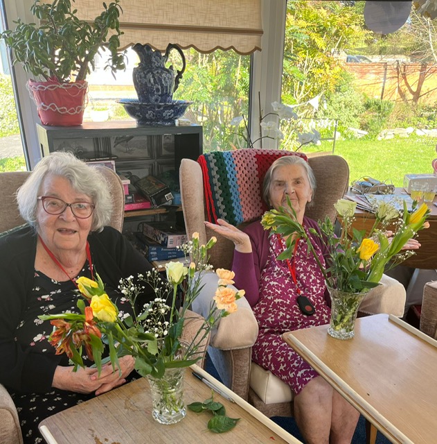 teo residents with their arranged flowers