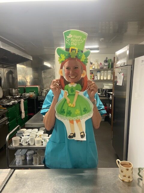 Carer holding a St. Patrick's Day decoration
