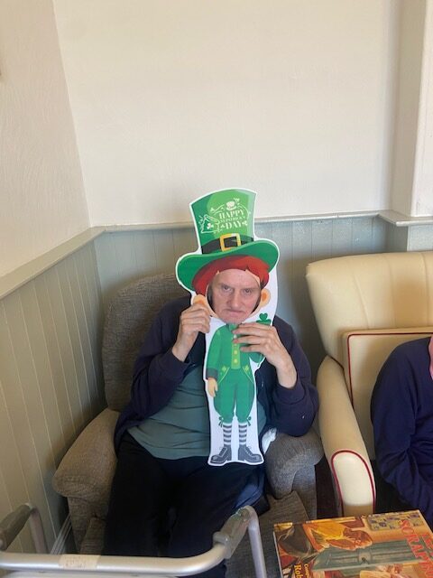 Male resident holding a St. Patrick's Day decoration