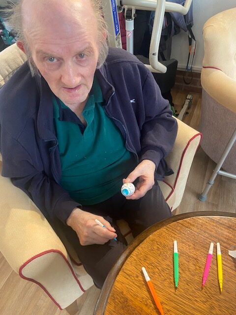 Resident decorating elements for his Easter bonnet