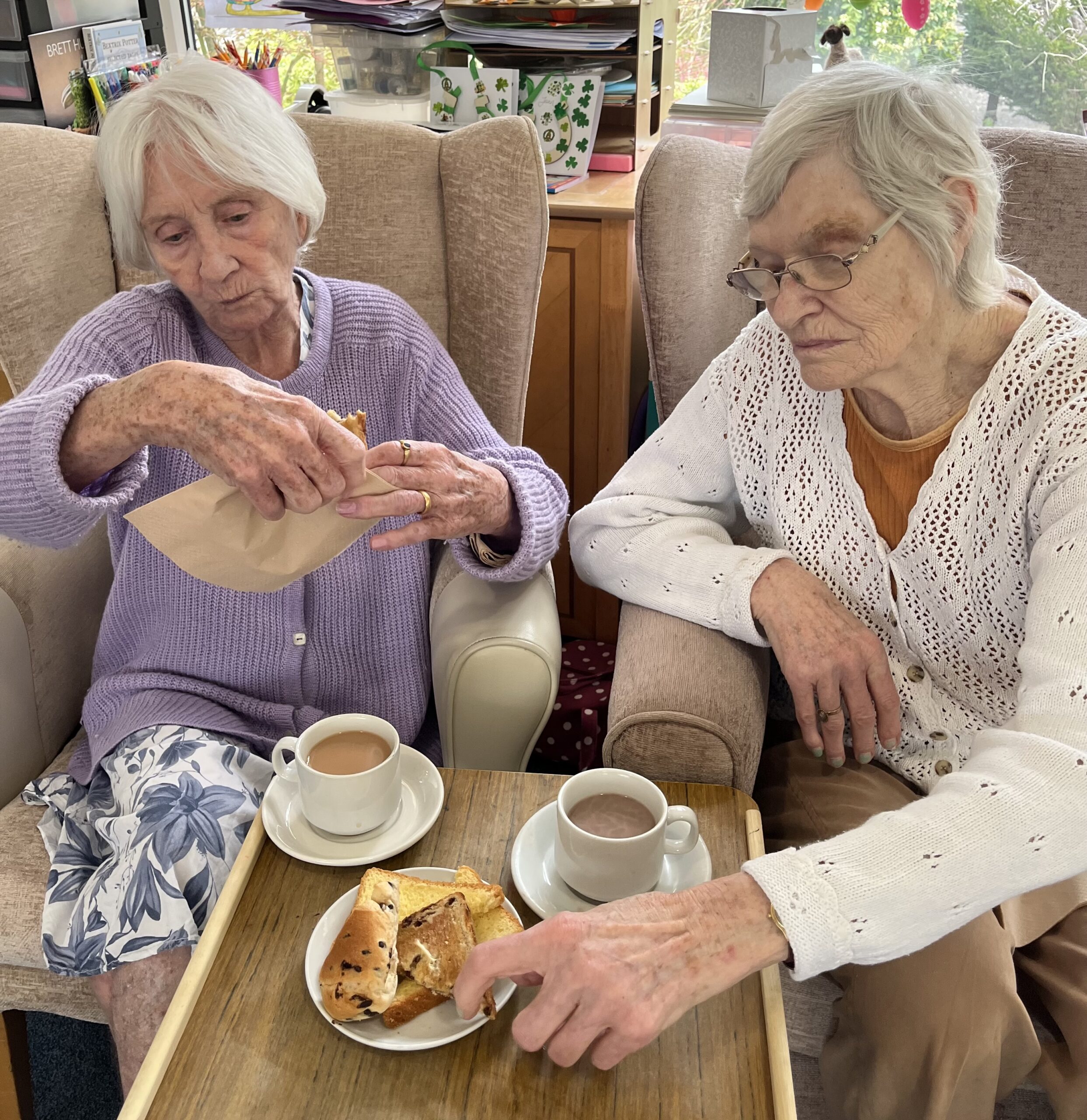 Residents enjoying a slice of sweet loaf and a cup of tea