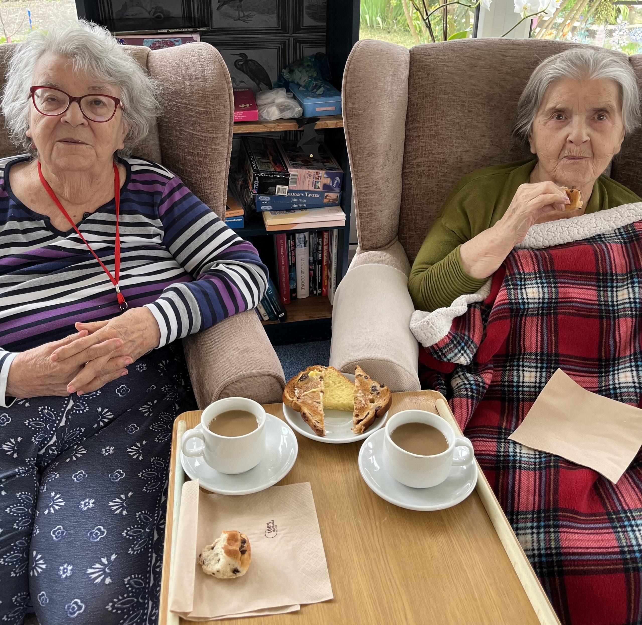 Residents enjoying a slice of sweet loaf and a cup of tea