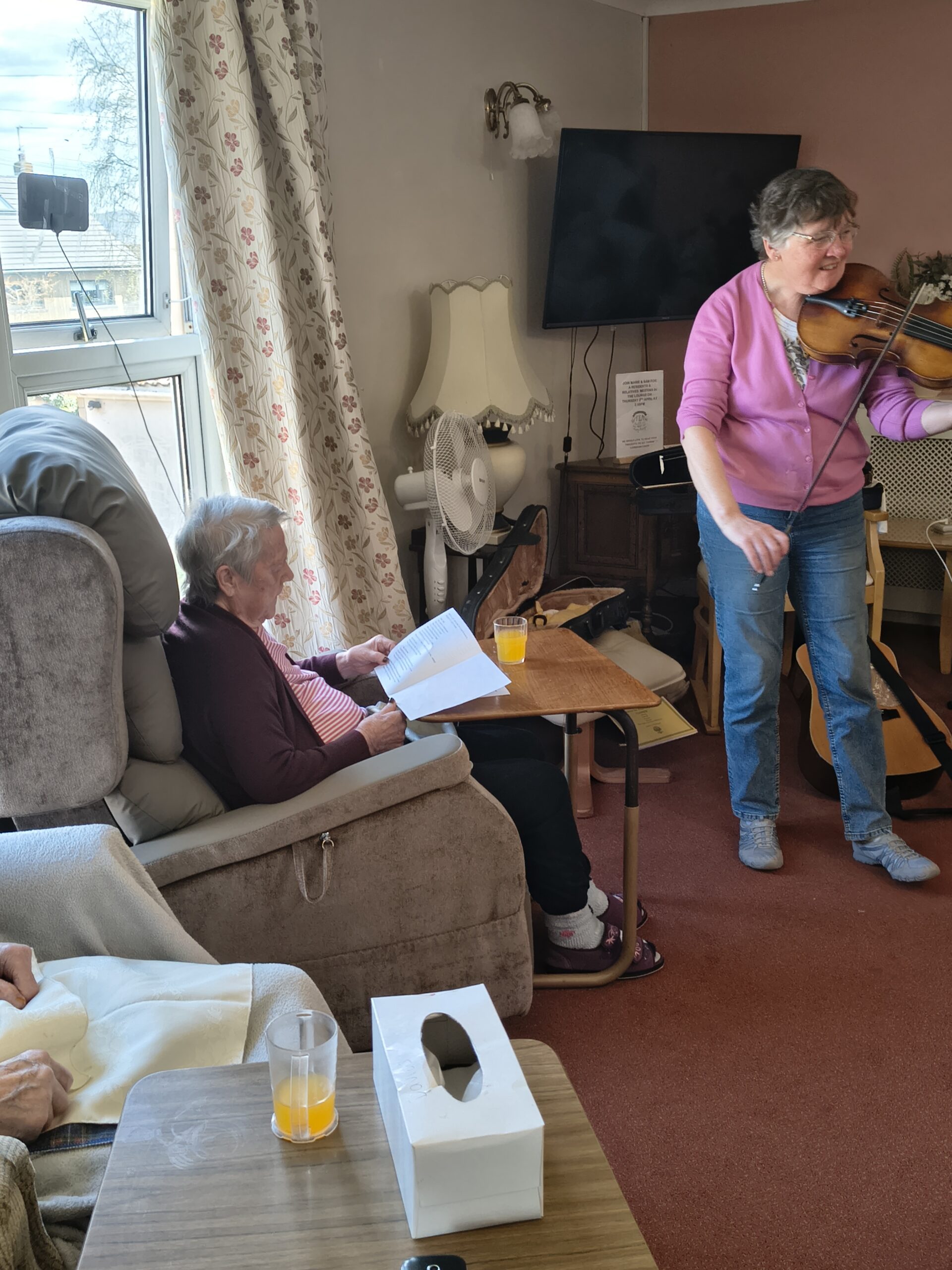 Alison playing the viola with residents watching scaled