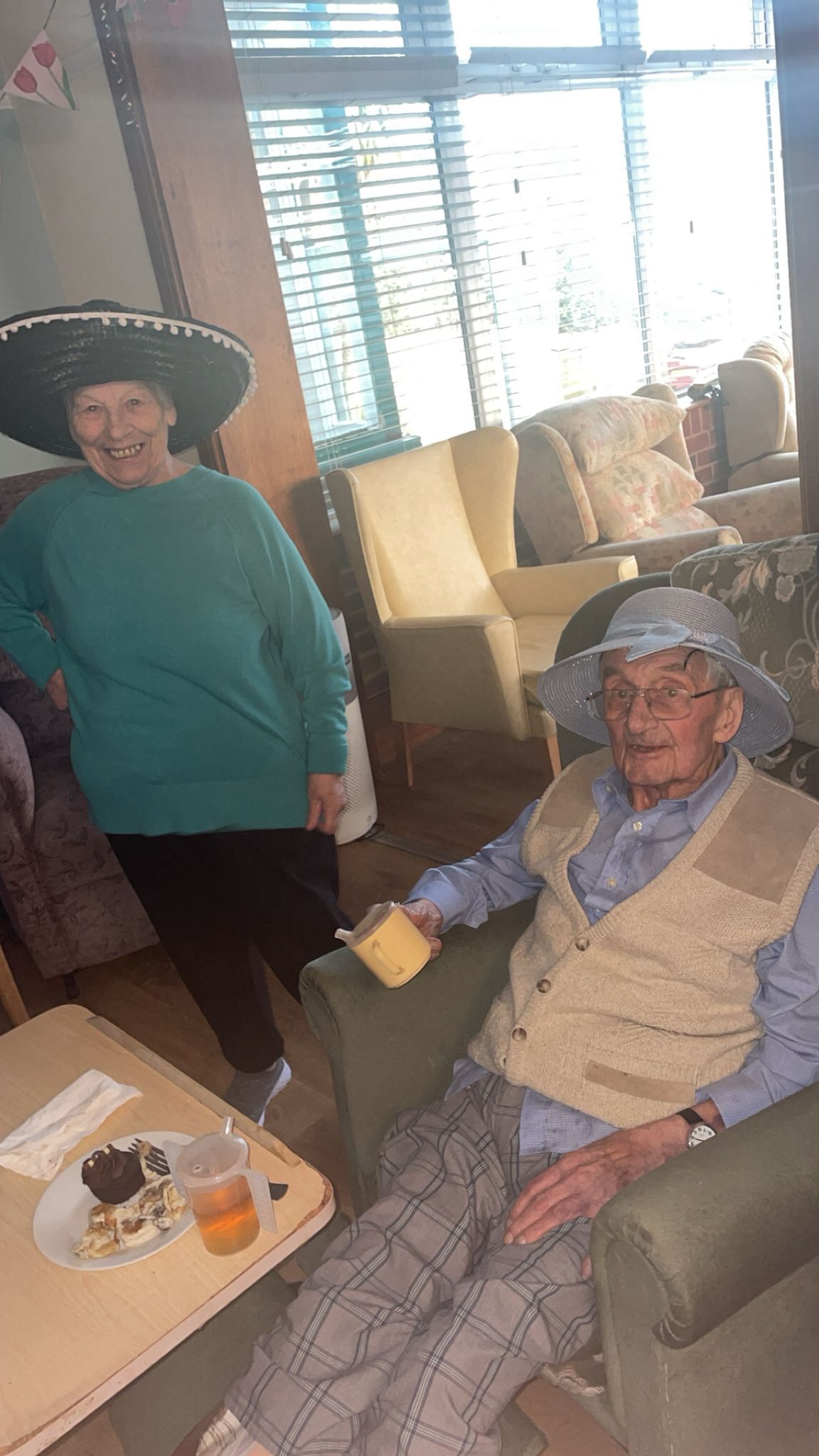 Ange in a black sombrero Gordon in a pale blue bonnet