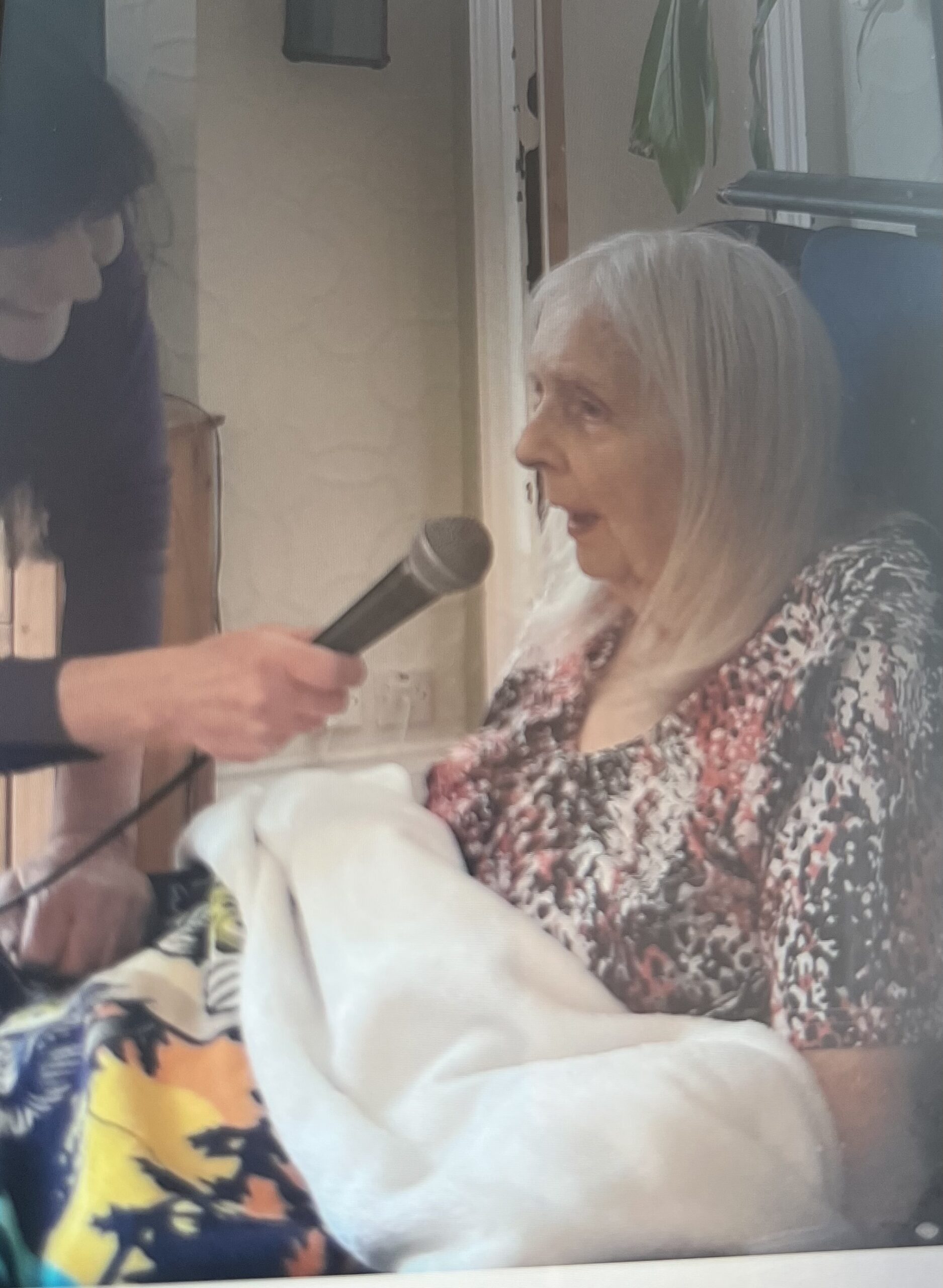 Anthea singing beautifully into a microphone scaled