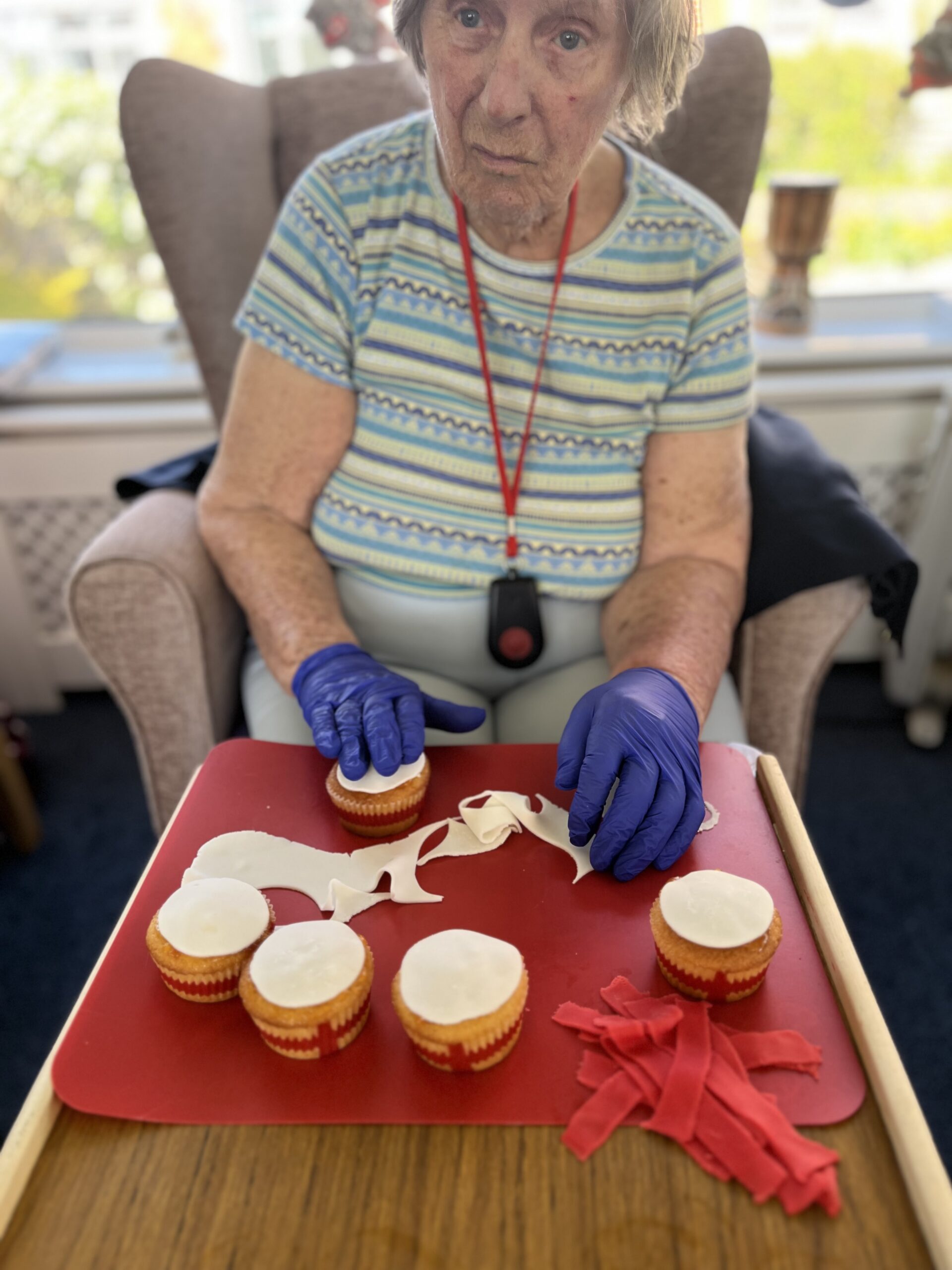 Barb placing white icing circles onto cupcakes scaled
