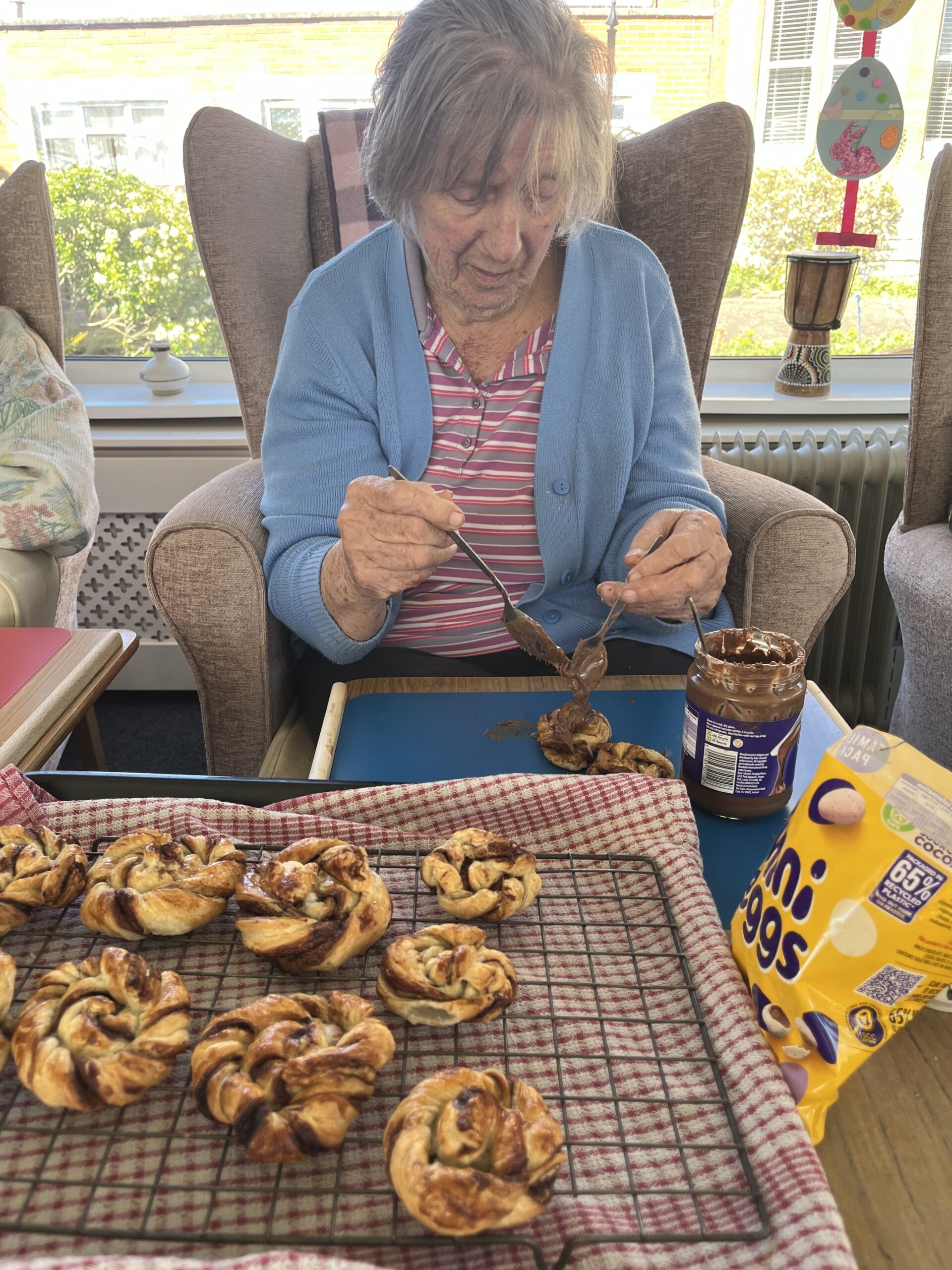 Barb topping the nests with chocolate spread and mini eggs