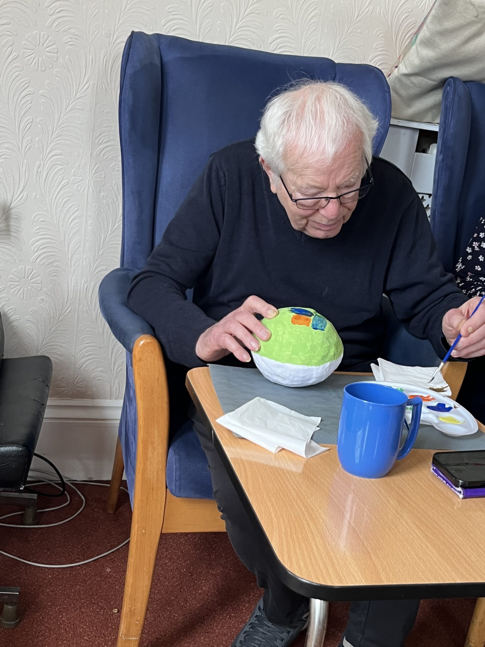 Brian decorating his Easter egg with paint
