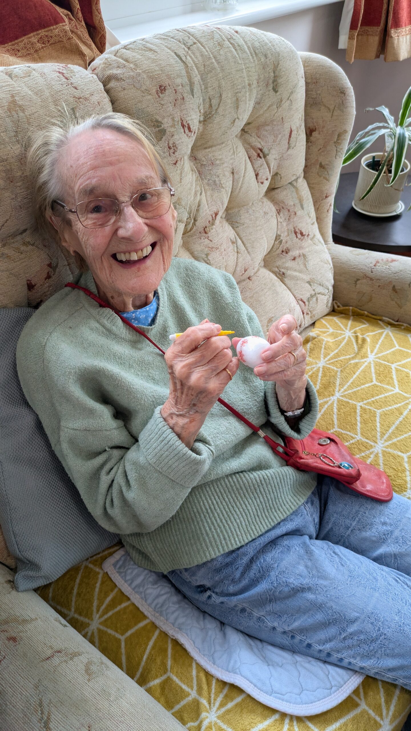 Cecily decorating her foam Easter egg with yellow felt-tip pen