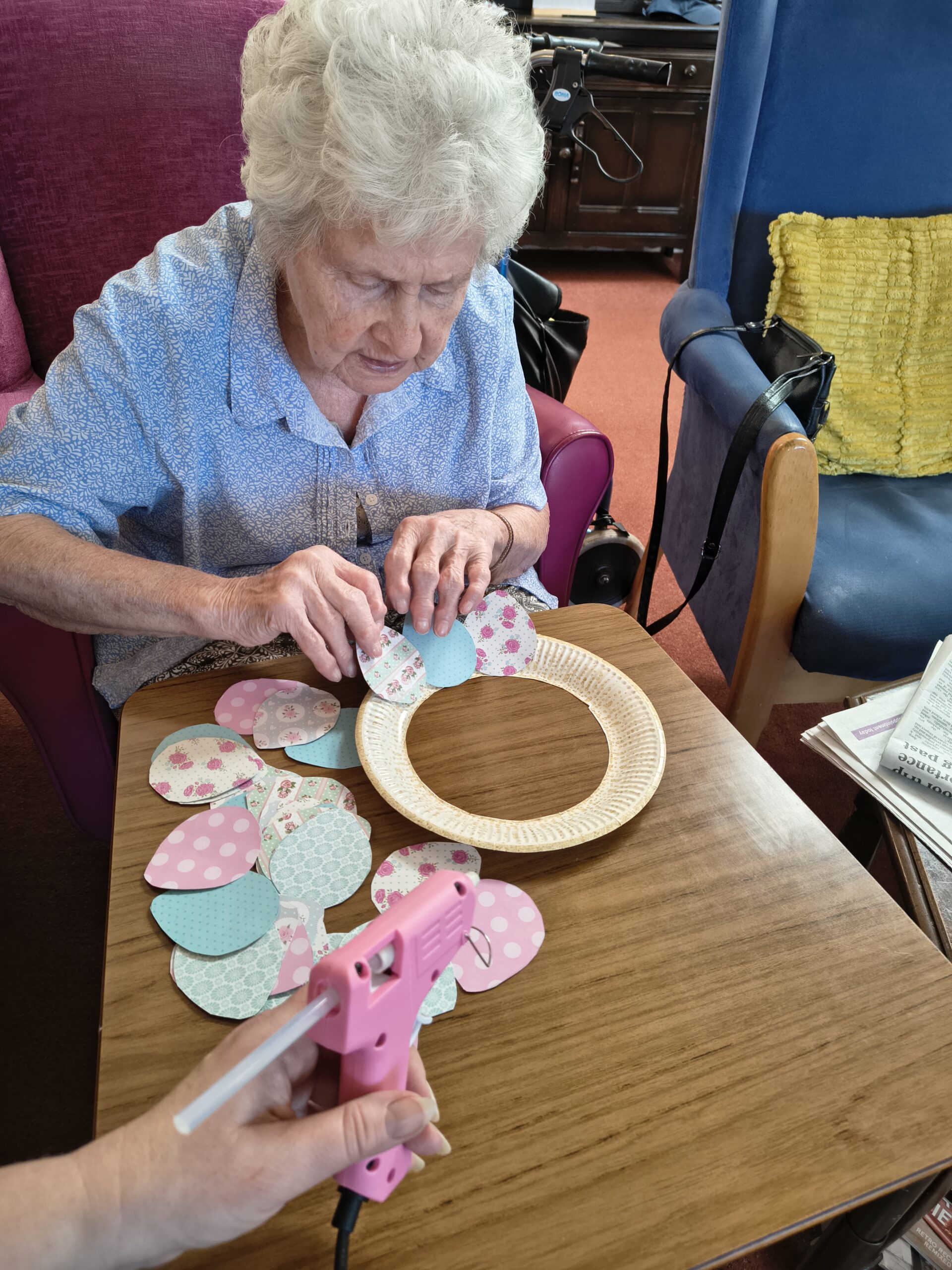 Female resident sticking paper pattern eggs around the wreath 2 scaled