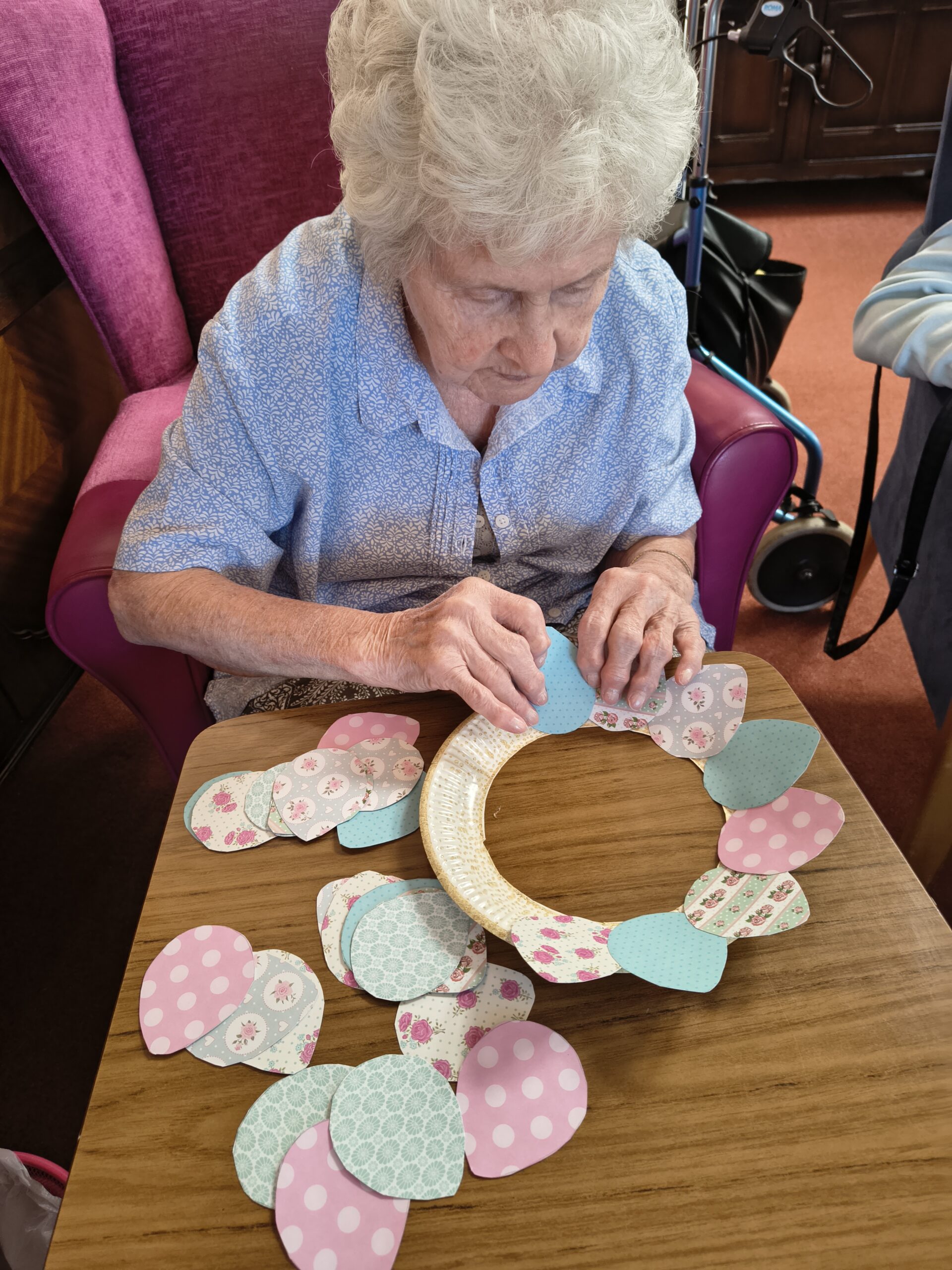 Female resident sticking paper pattern eggs around the wreath 3 scaled