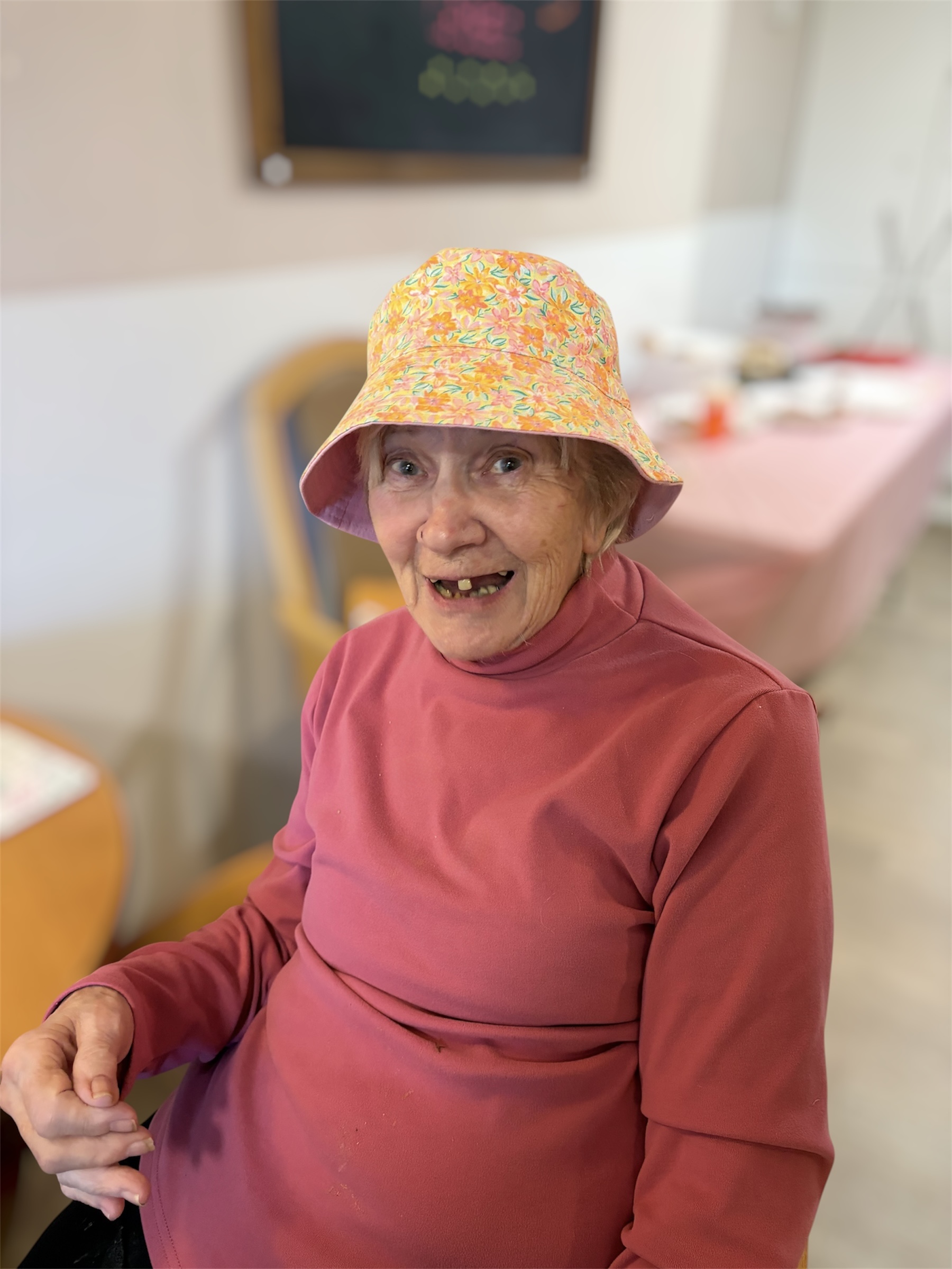 Female resident wearing a yellow-flower print bucket hat