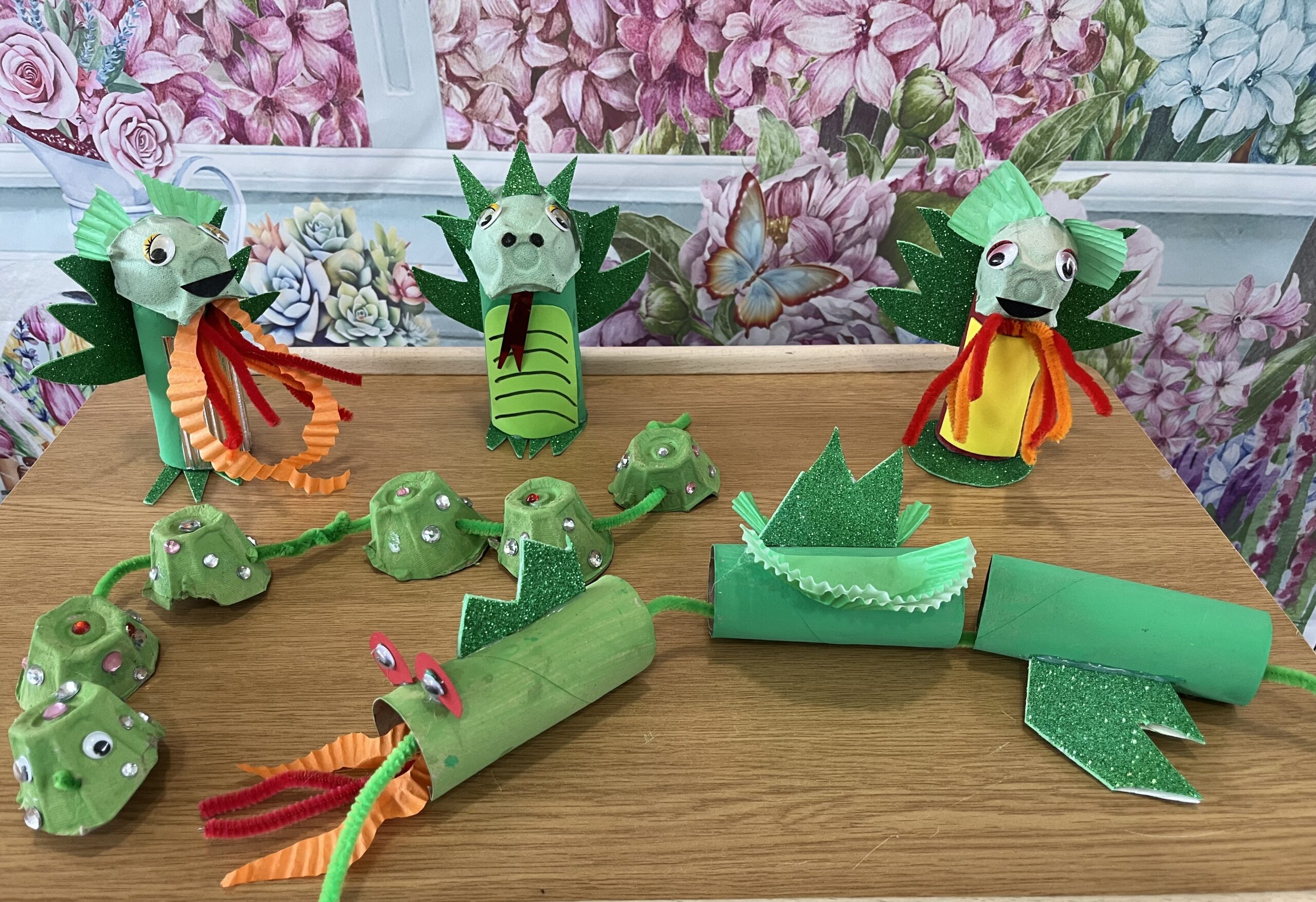 Finished dragons all made of toilet rolls, egg boxes and decorated with pipe cleaner, paper and sequins
