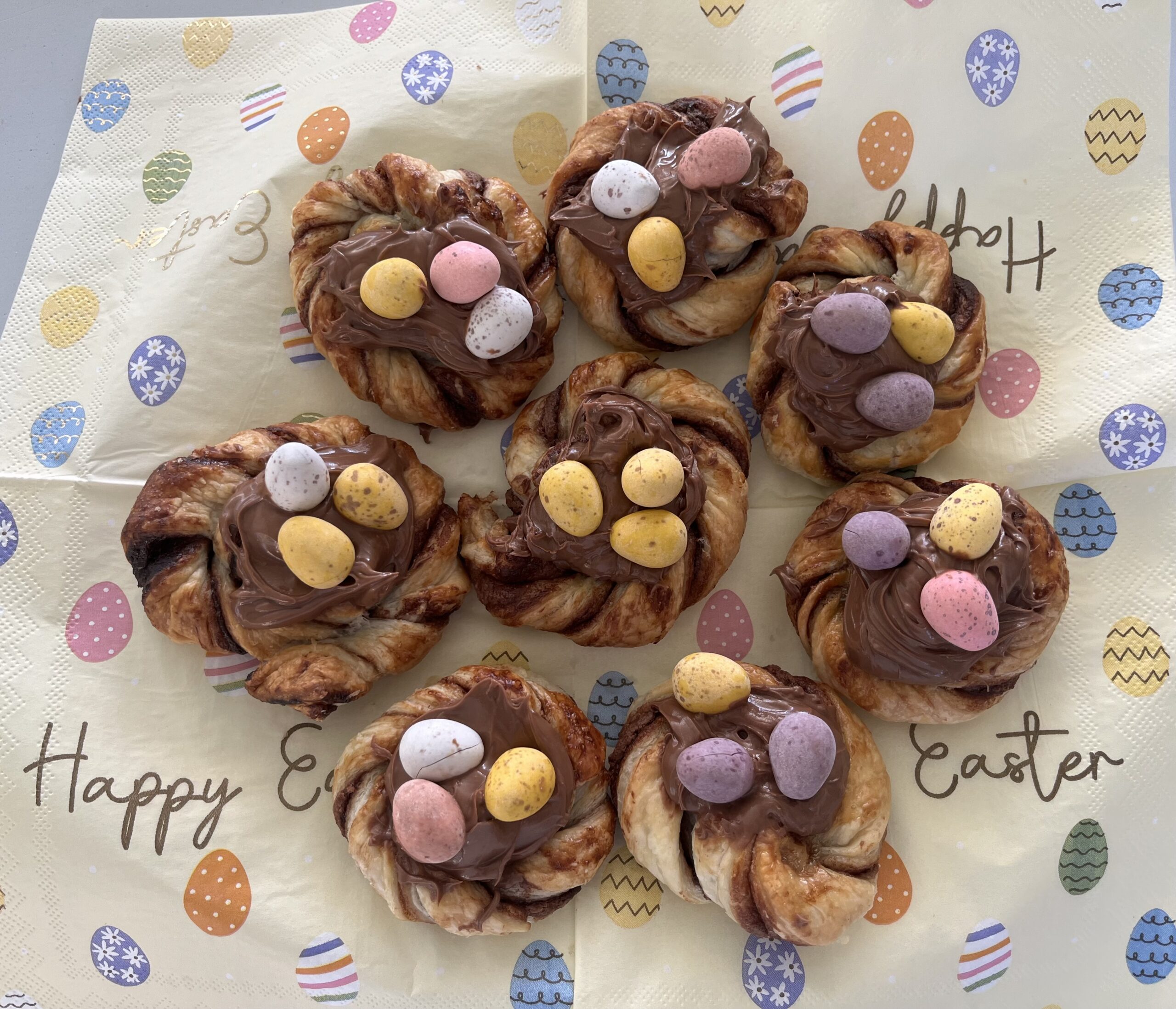 Finished puff pastry chocolate nests topped with chocolate mini eggs