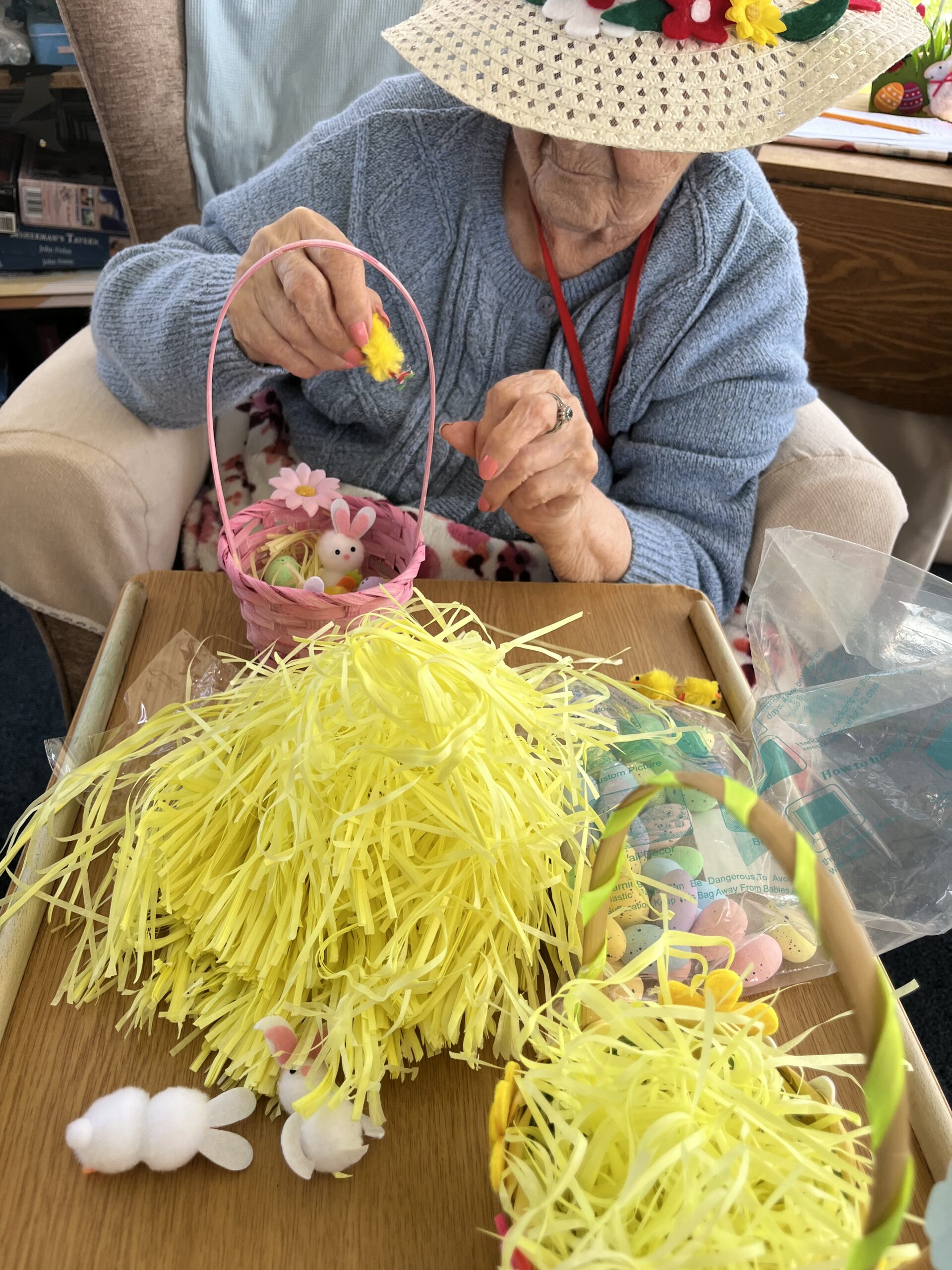 Herta filling her pale pink Easter basket with eggs fluffy rabbits and chicks scaled