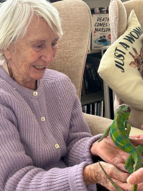 Jean holding a Chameleon in her open hands