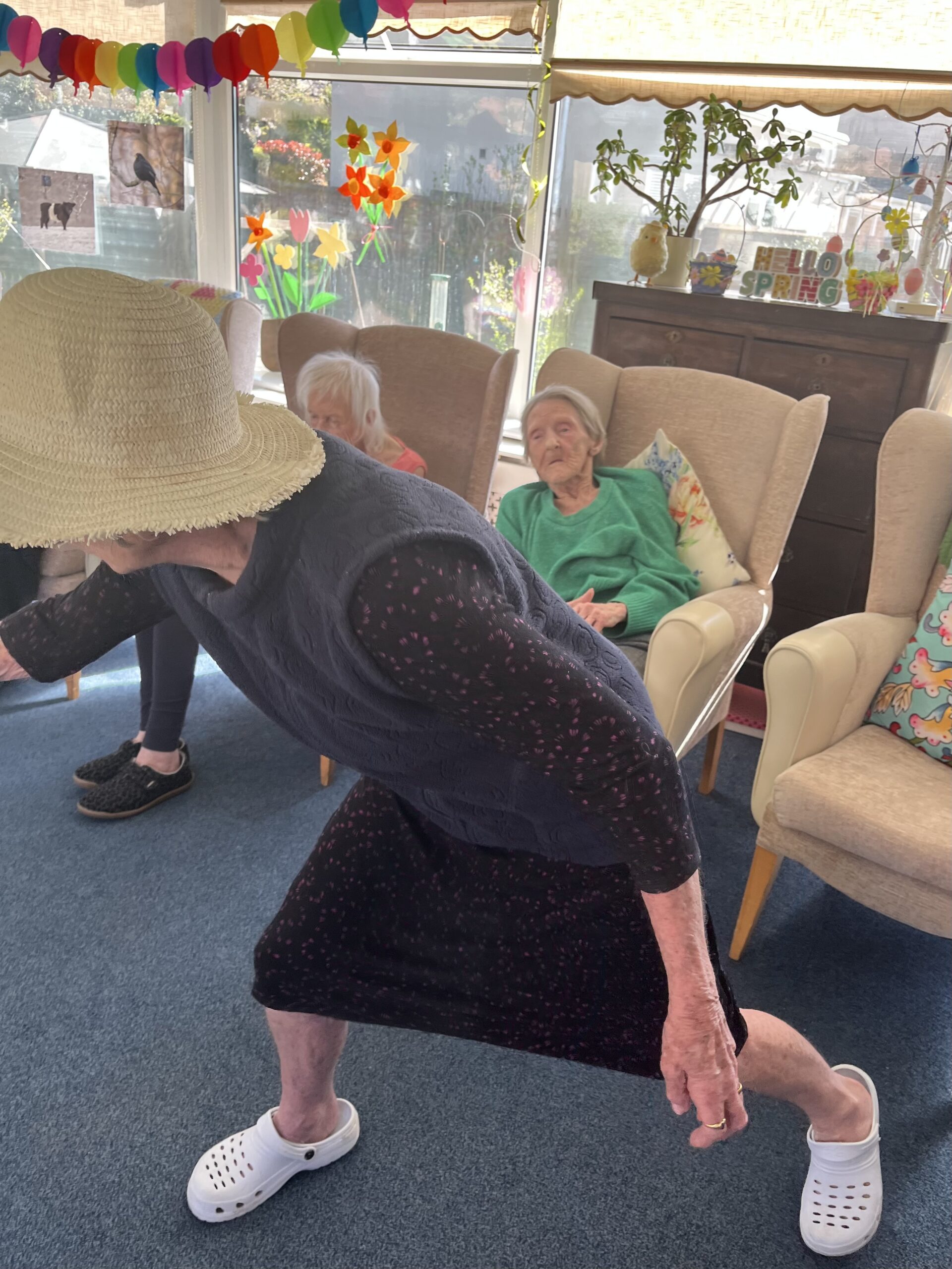 Jean loosing a tennis ball from her racket whilst standing scaled