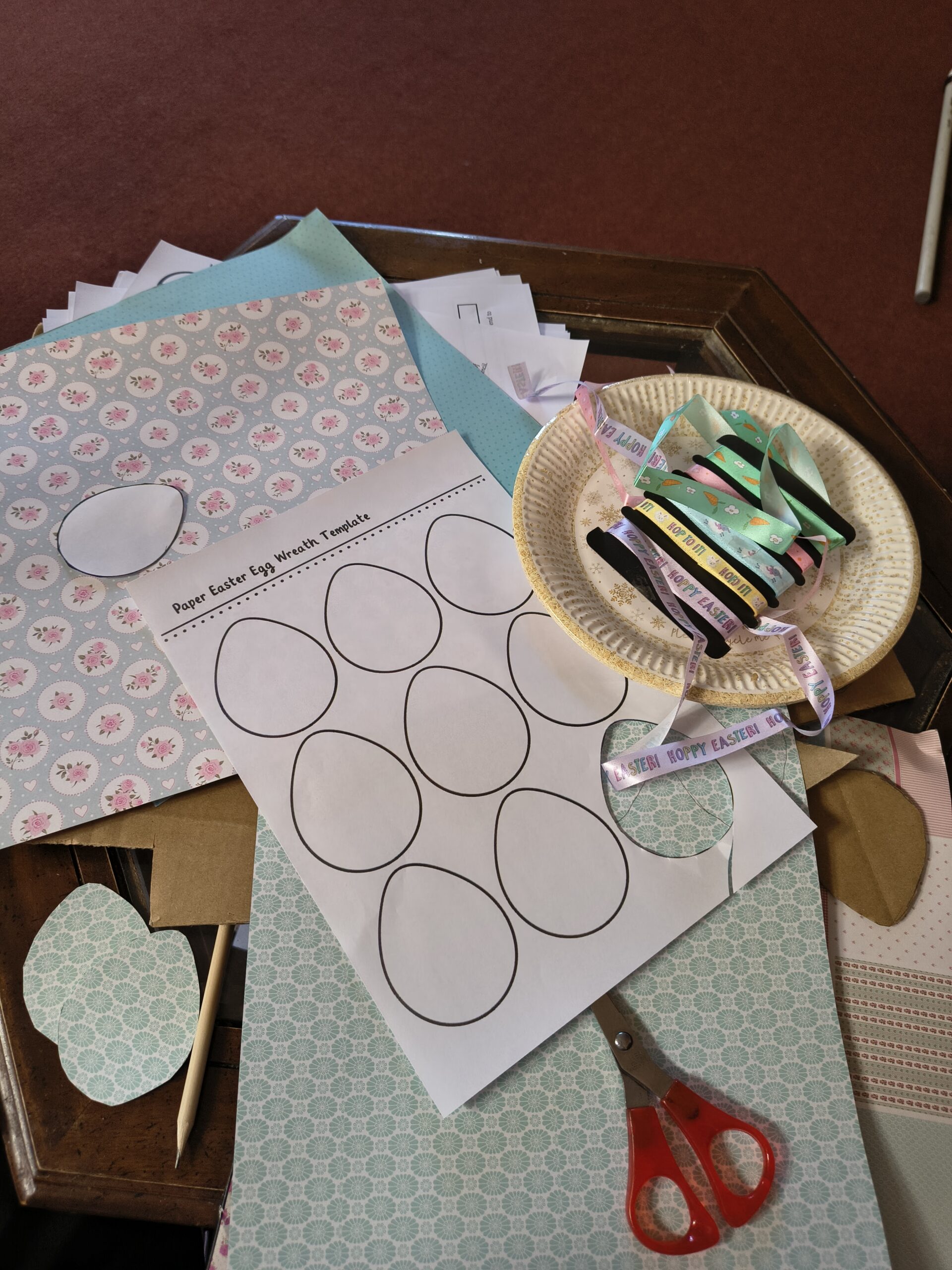 Materials used to make egg wreath pattern paper and ribbon scaled