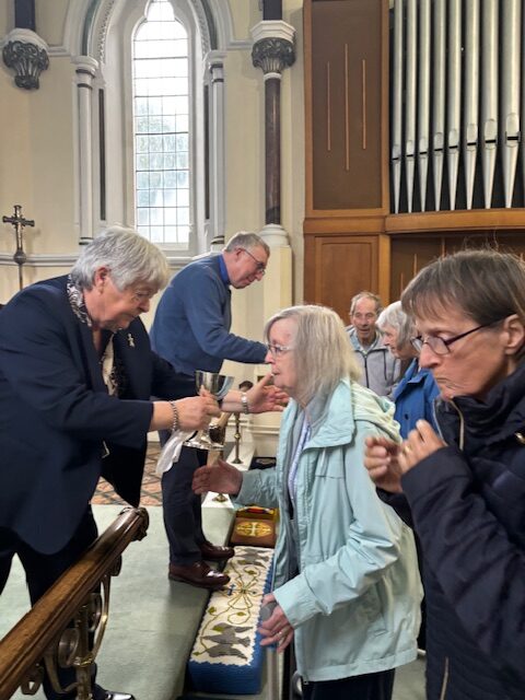 Pastor Kim giving Holy Communion to the church