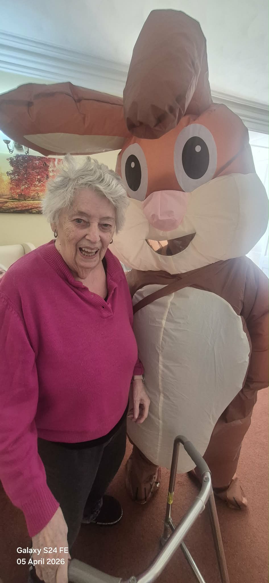 Resident posing for a photo with the Easter bunny