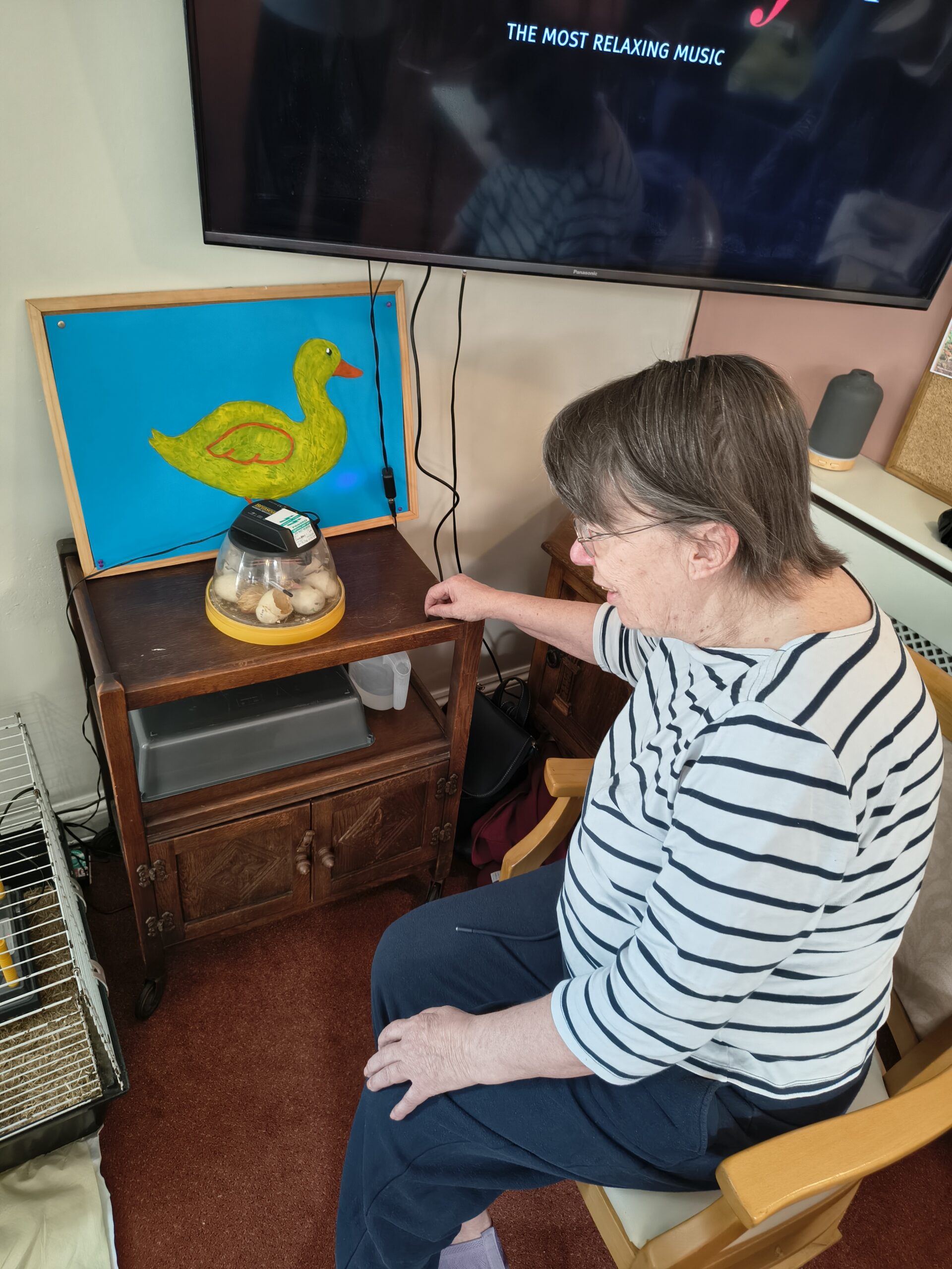 Resident seated beside the incubator scaled