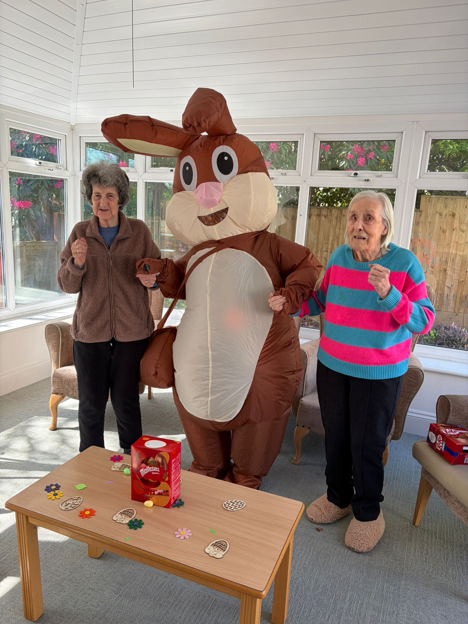 Residents dancing with the Easter bunny in the conservatory