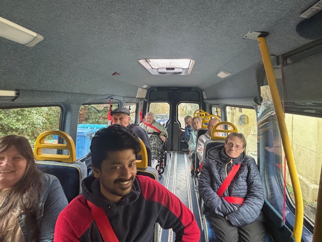 Residents in the back of the minibus smiling and ready to go