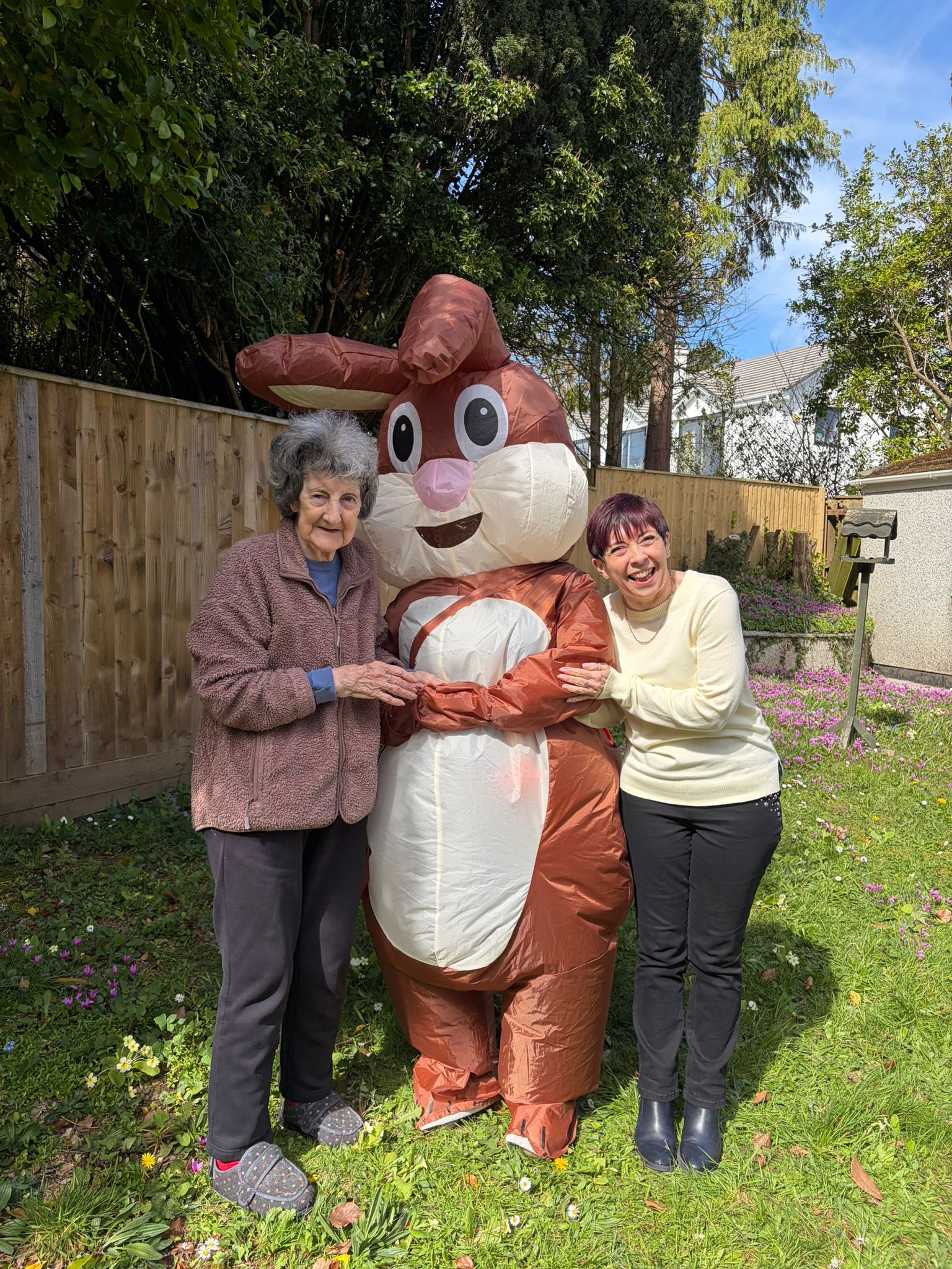Residents outside in the garden posing for a photo with the Easter bunny