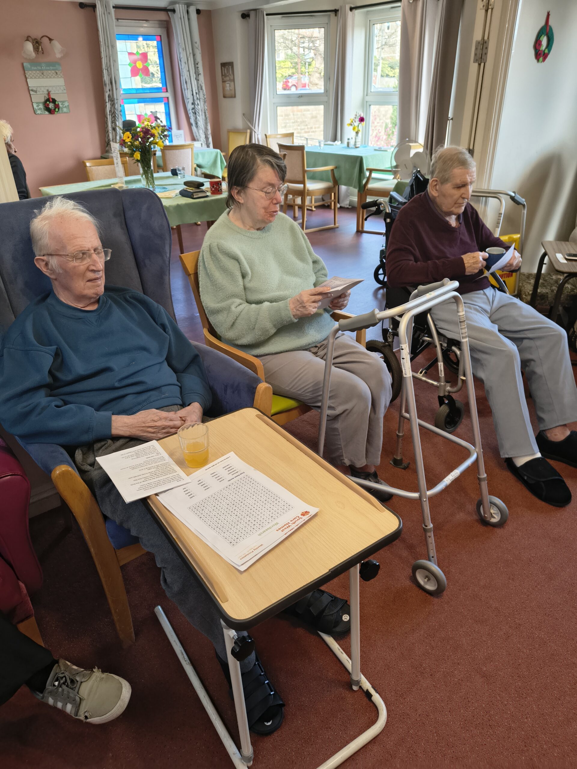 Residents seated listening to Alison looking at programmes scaled