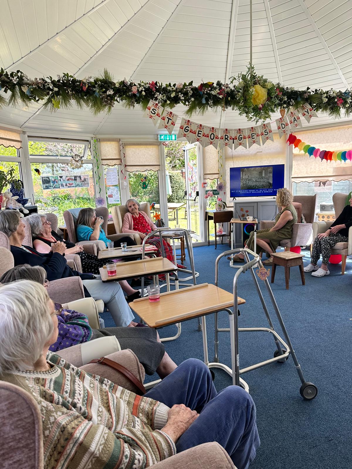 Residents seated together listening to the fun facts and quiz questions