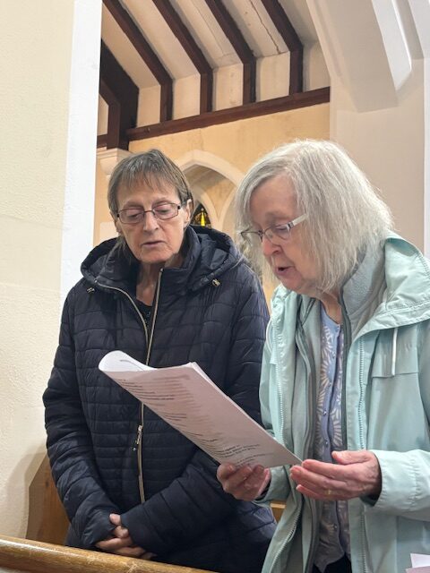 Residents stood singing a hymn