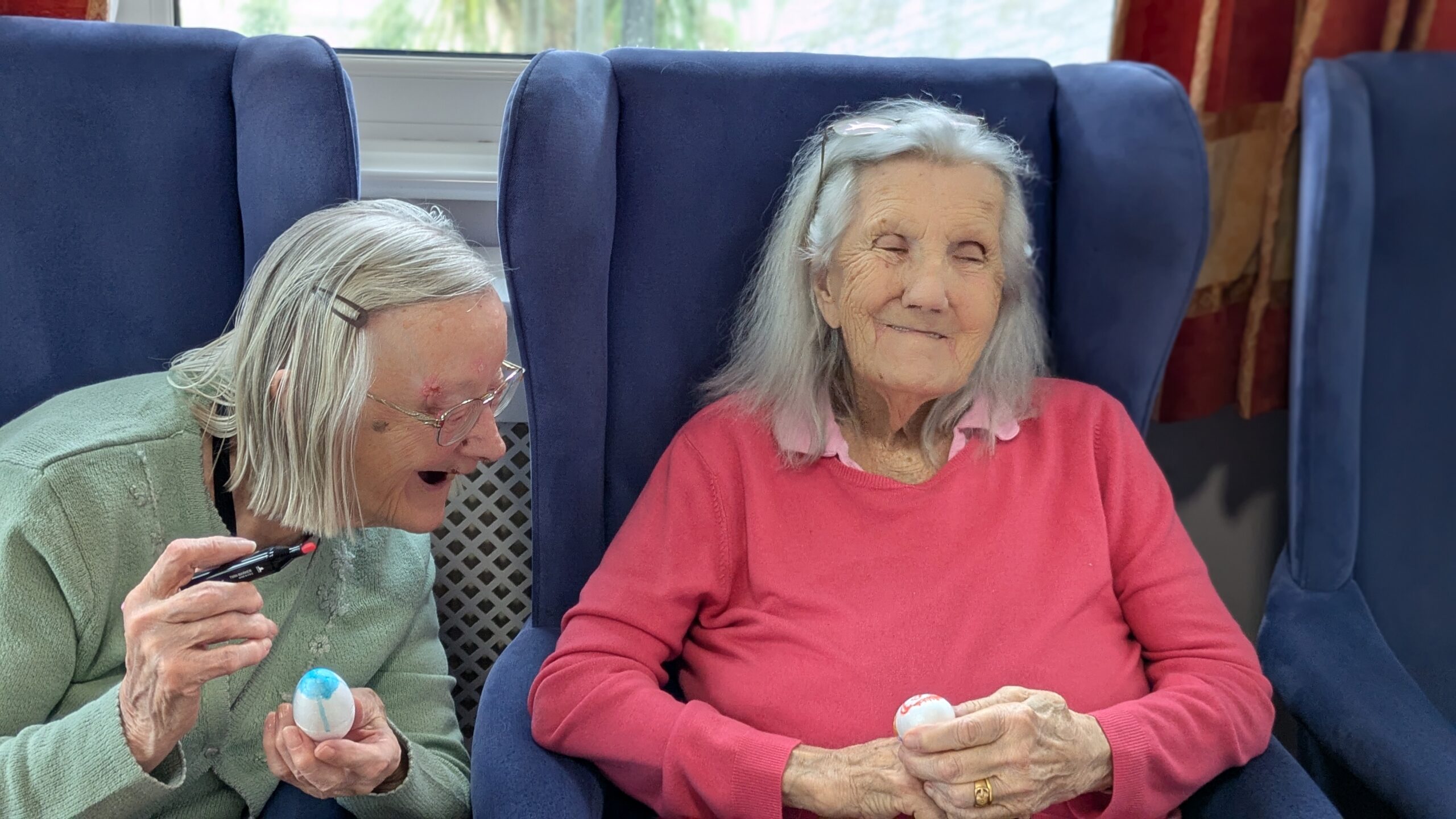 Ruth and Wyn looking at each other's egg designs