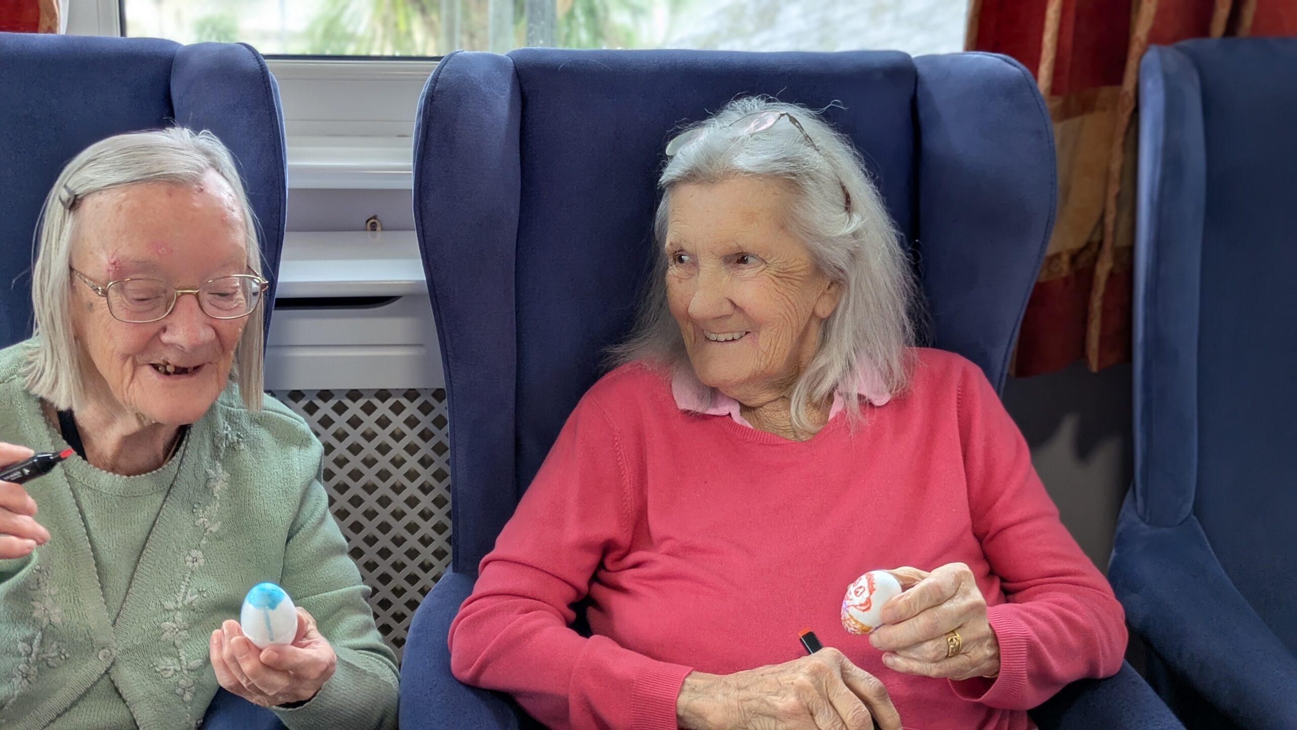 Ruth and Wyn looking at each other's egg designs