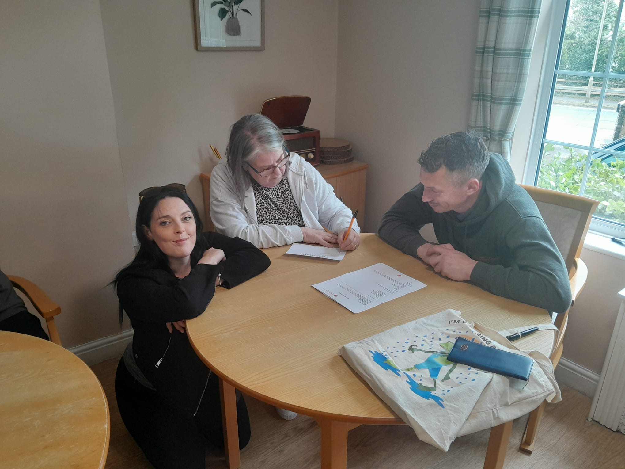 Table of three completing exercise sheet