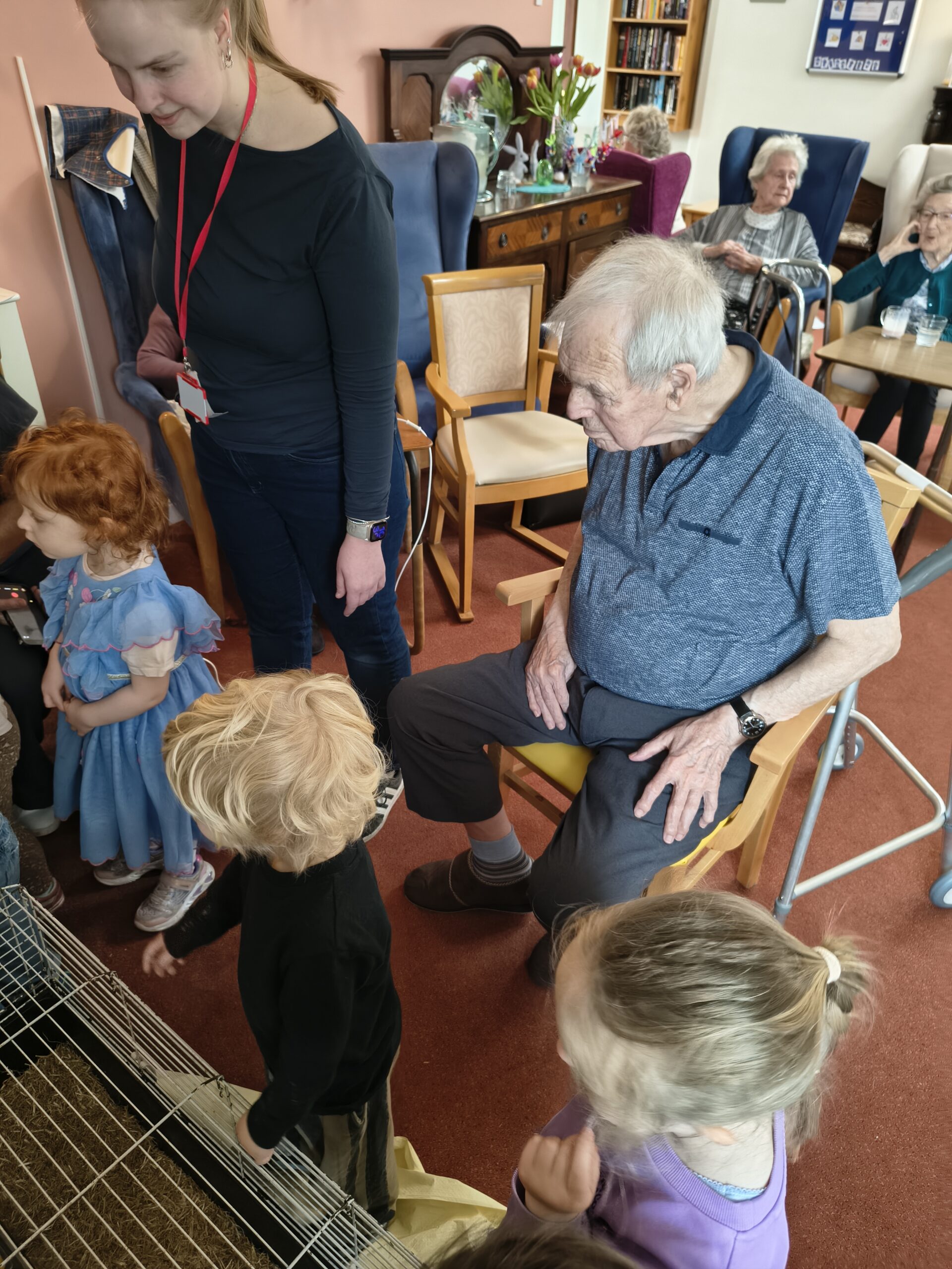 Toddlers and residents looking intently at the incubator scaled