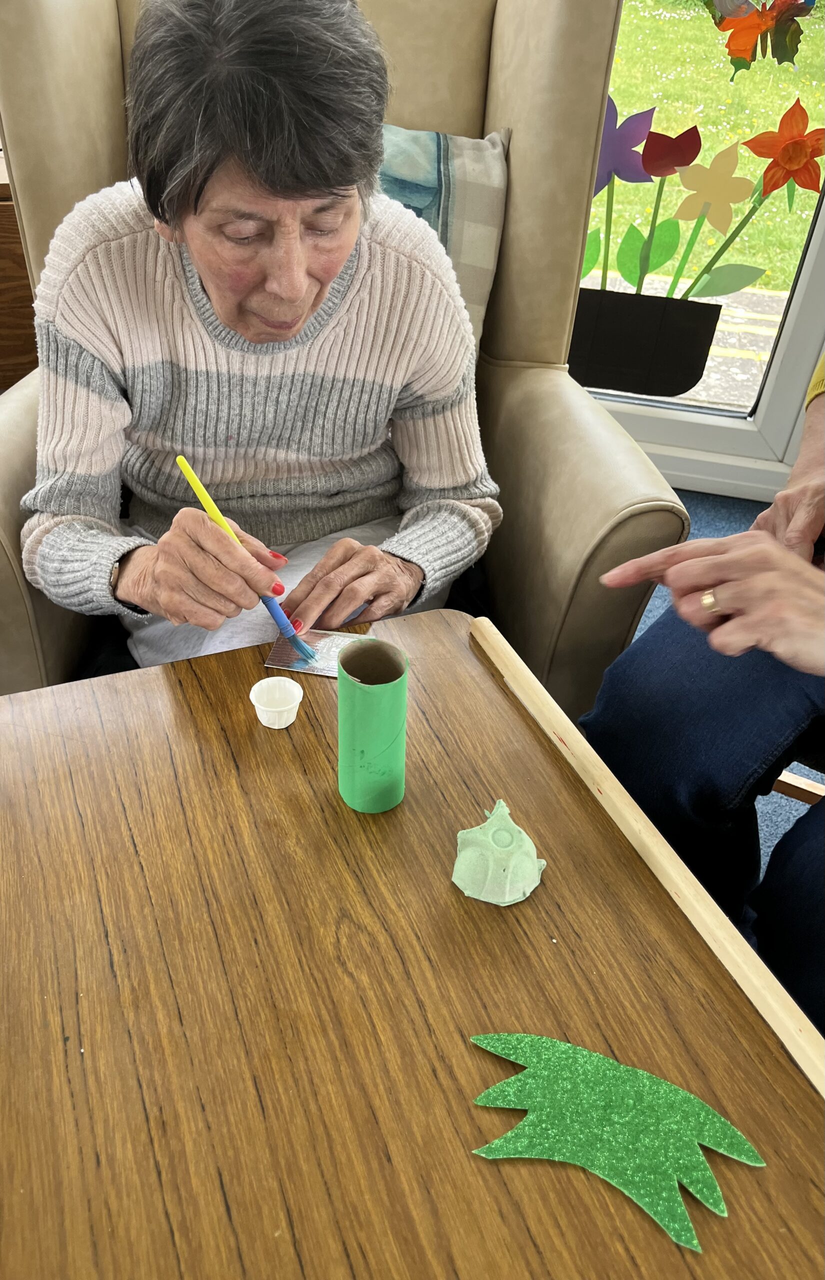 Violet gluing wings to her dragon