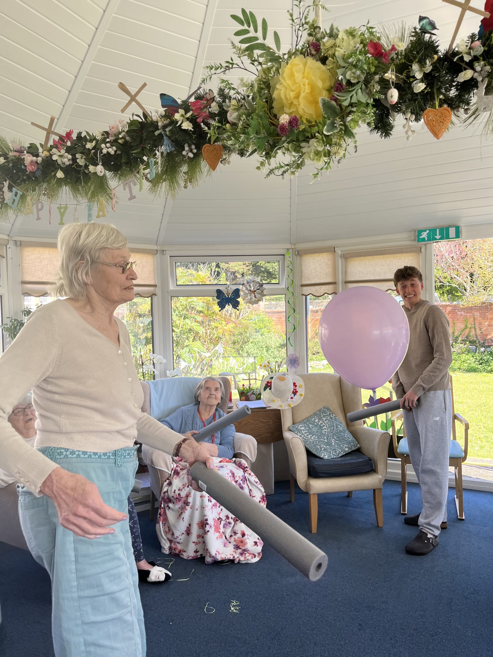 Wendy hitting a balloon with a foam insulation pipe scaled