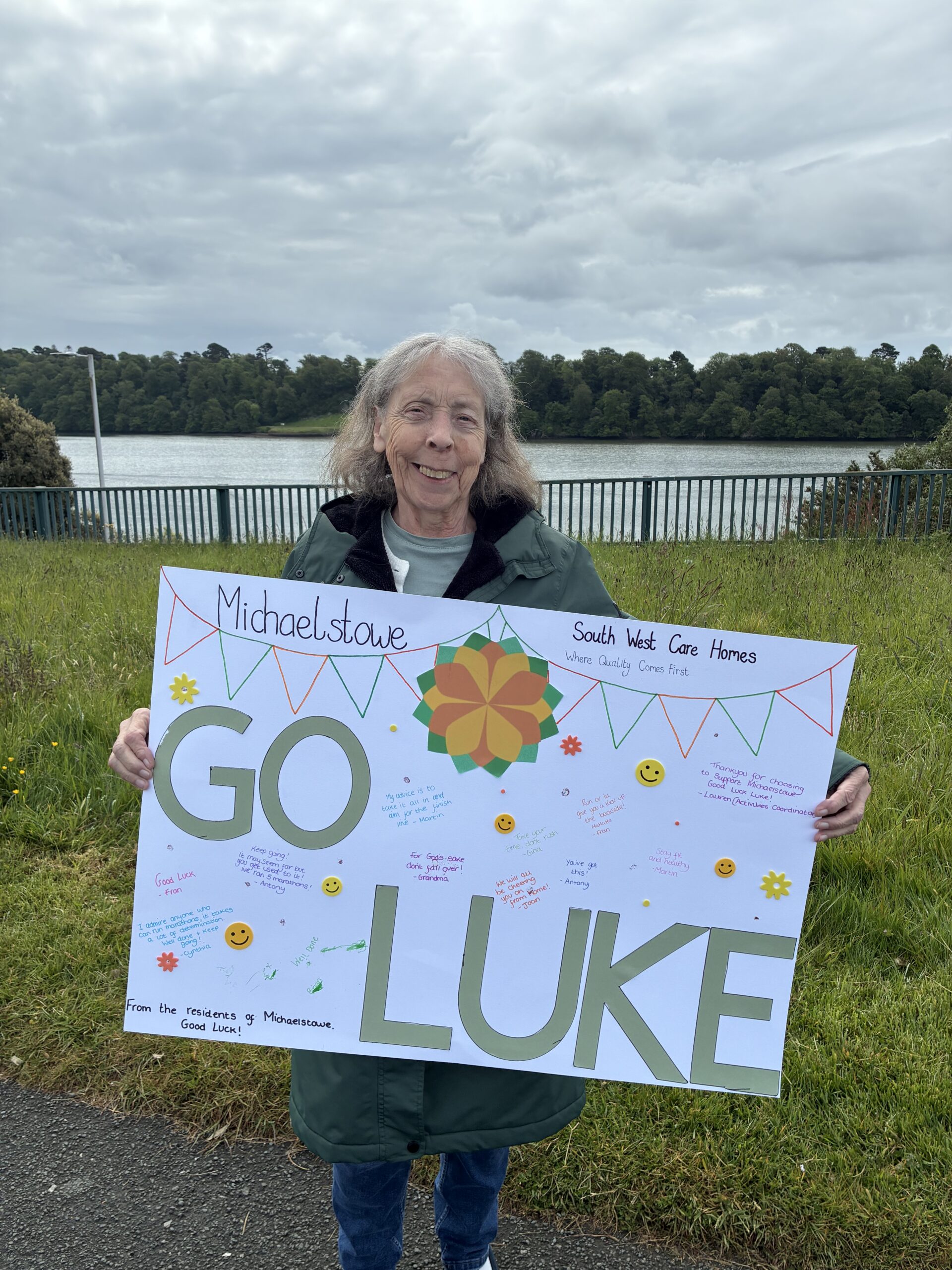 Carol outside holding a homemade Go Luke sign