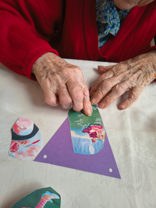 Close-up of a resident sticking a picture of Alice to her bunting