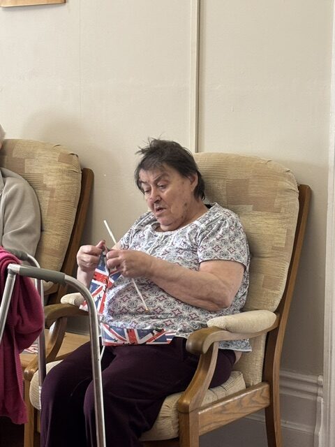 Female resident having waved her Union Jack so much it came off the stick