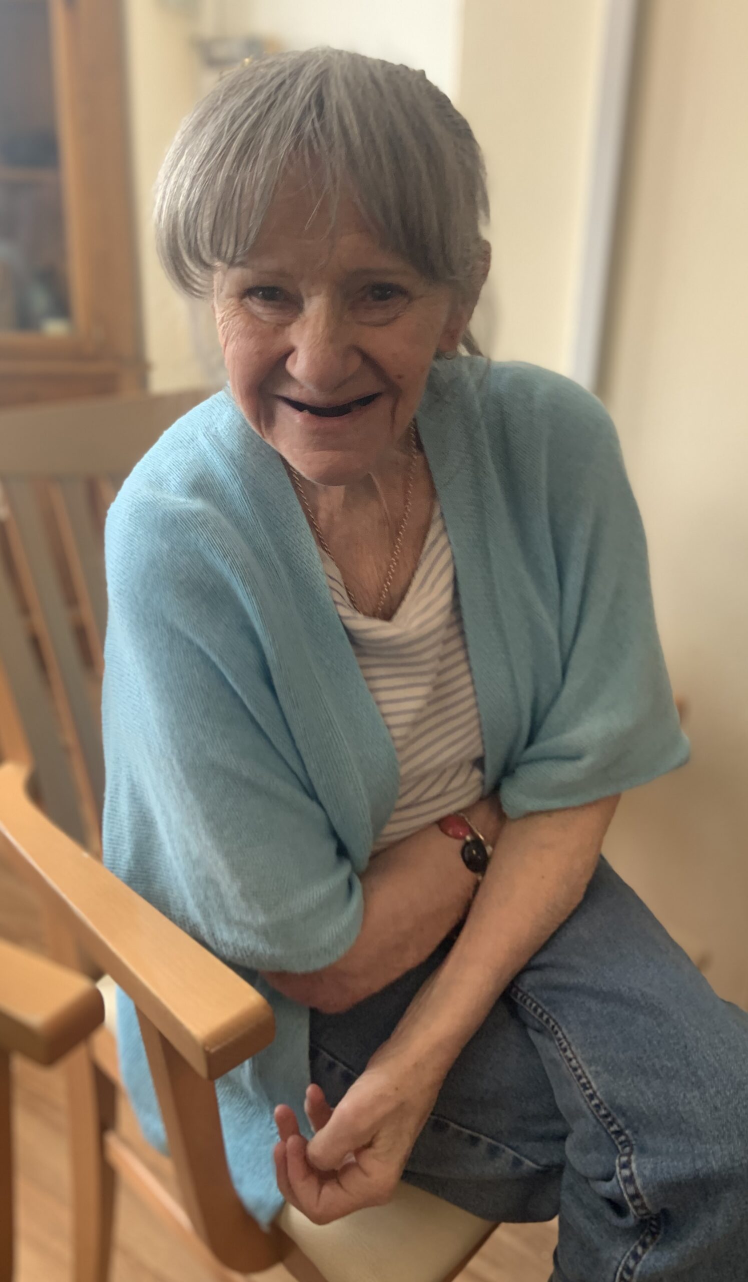 Female resident seated smiling for the camera