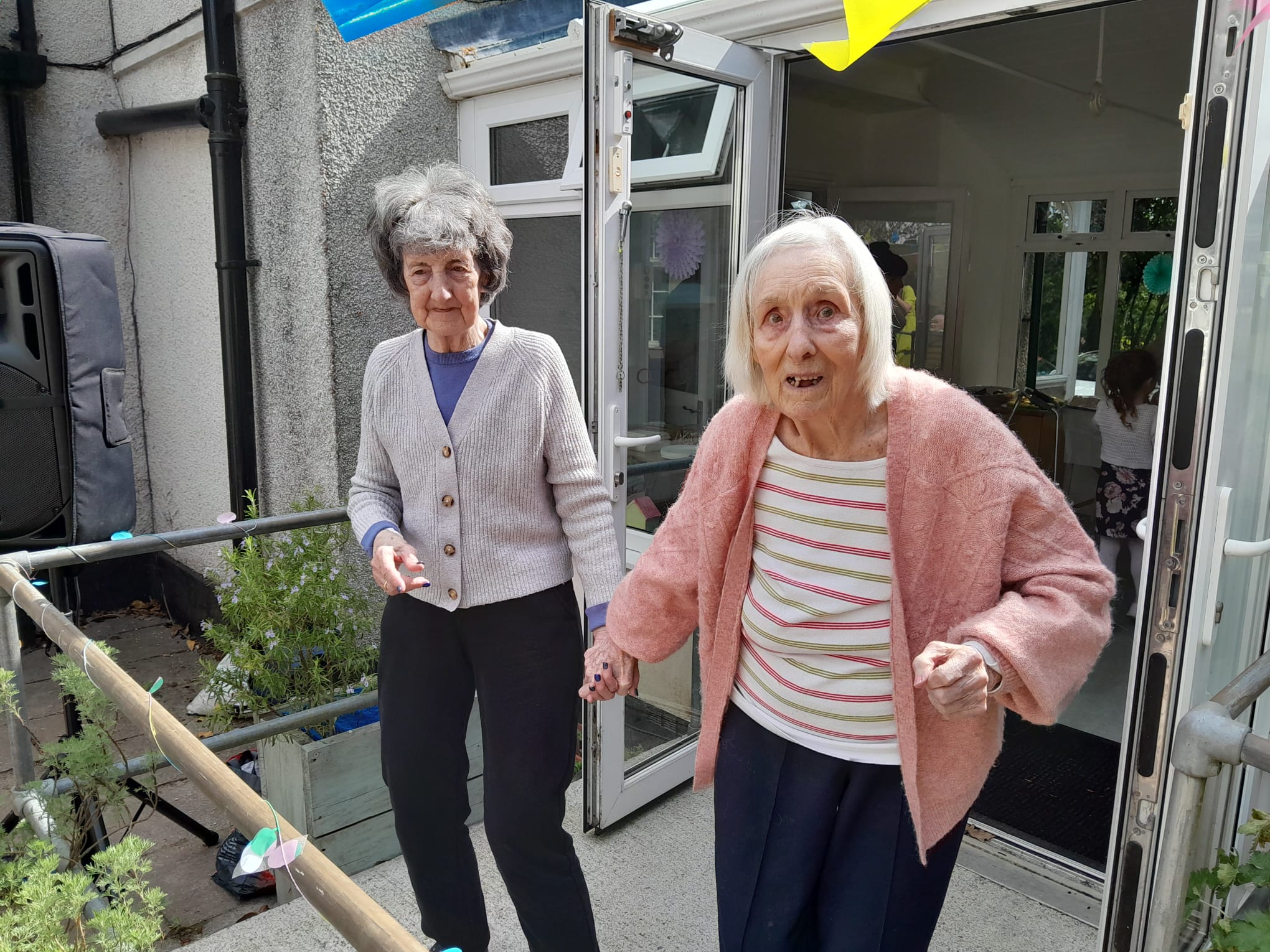 Muriel and Jean hand-in-hand dancing